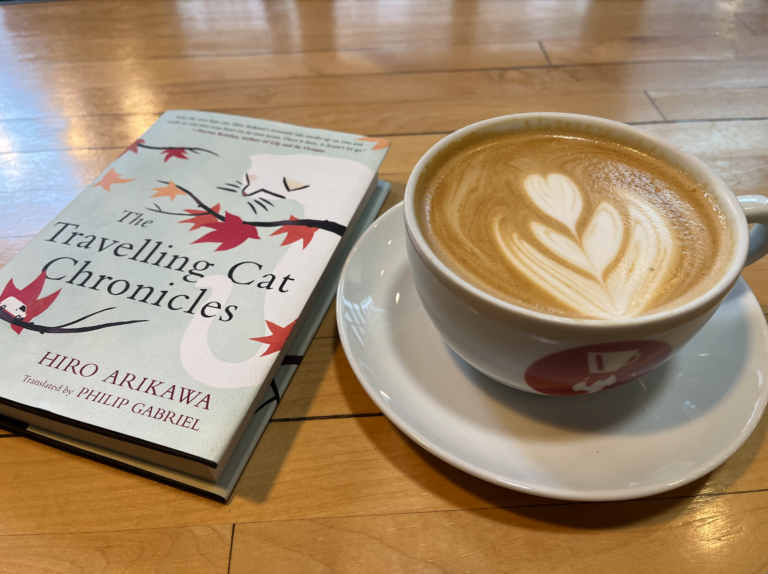 Picture of a book next to a latte.